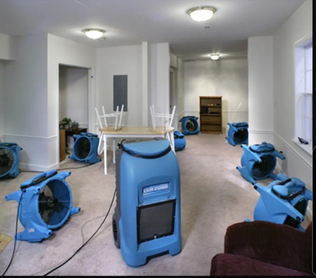 Air movers and dehumidifier setup for Water Damage Restoration in Gray